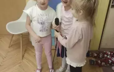 Trzy dziewczynki z grupy średniak&oacute;w śpiewają piosenkę